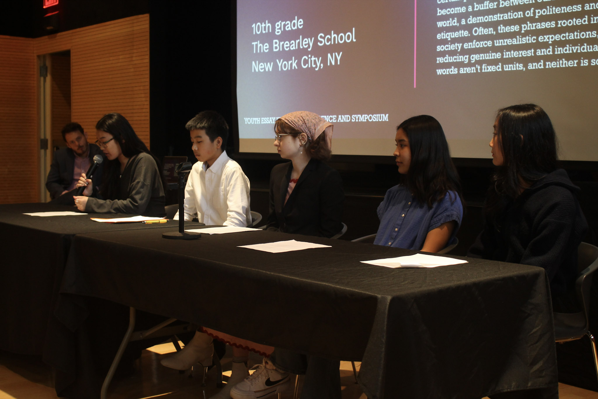 One panelist is talking into the microphone while the other Panelists are waiting