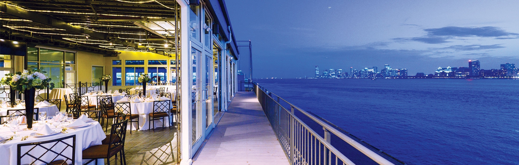 the view of the hudson river at sunset from a deck